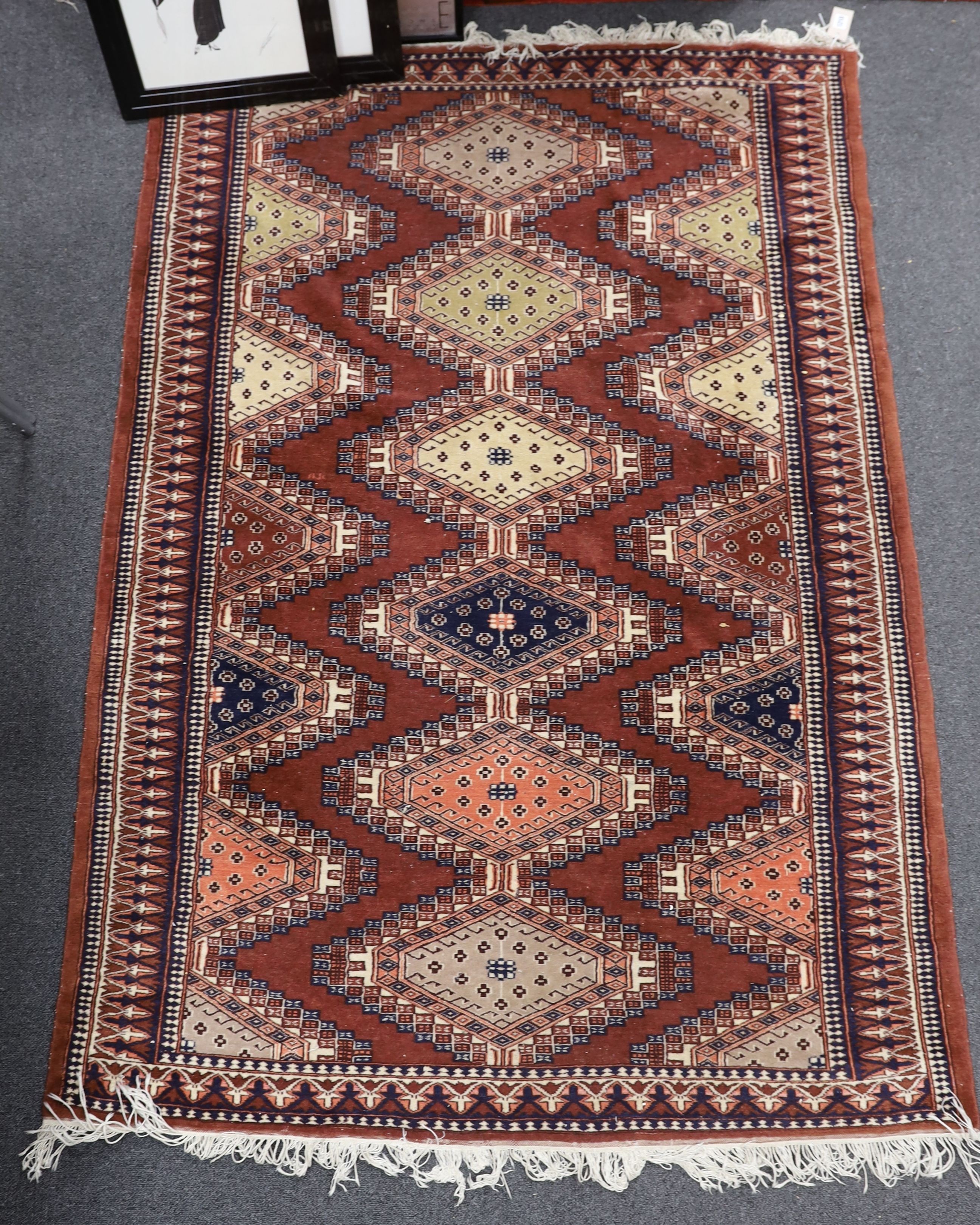 A Bokhara red ground rug, 180 x 124cm
